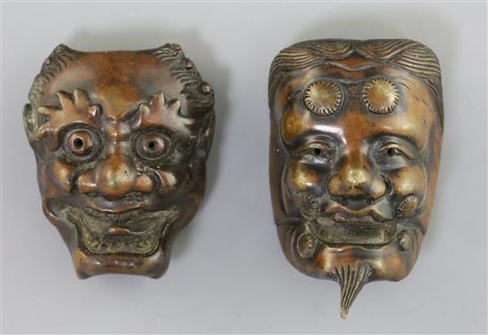 Two Japanese bronze models of noh masks, 19th century, H. 5.5 and 4.7cm